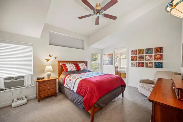 a bedroom with a bed and a window