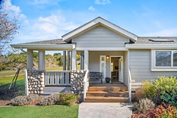 a front view of house with yard and outdoor seating