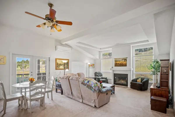 a living room with furniture fireplace and a window