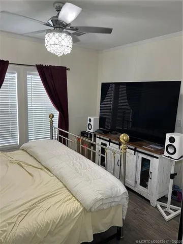 a spacious bedroom with a bed and a chandelier