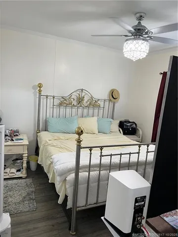 a bedroom with furniture and a chandelier