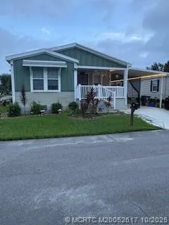 a front view of a house with a garden and patio