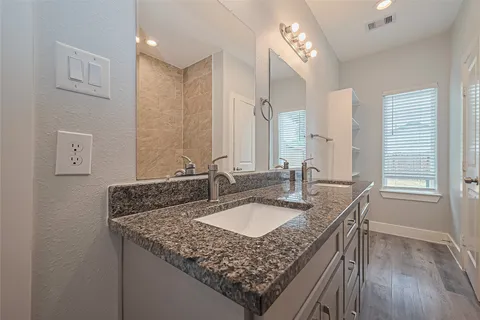 a bathroom with sinks granite countertop a sink and a mirror