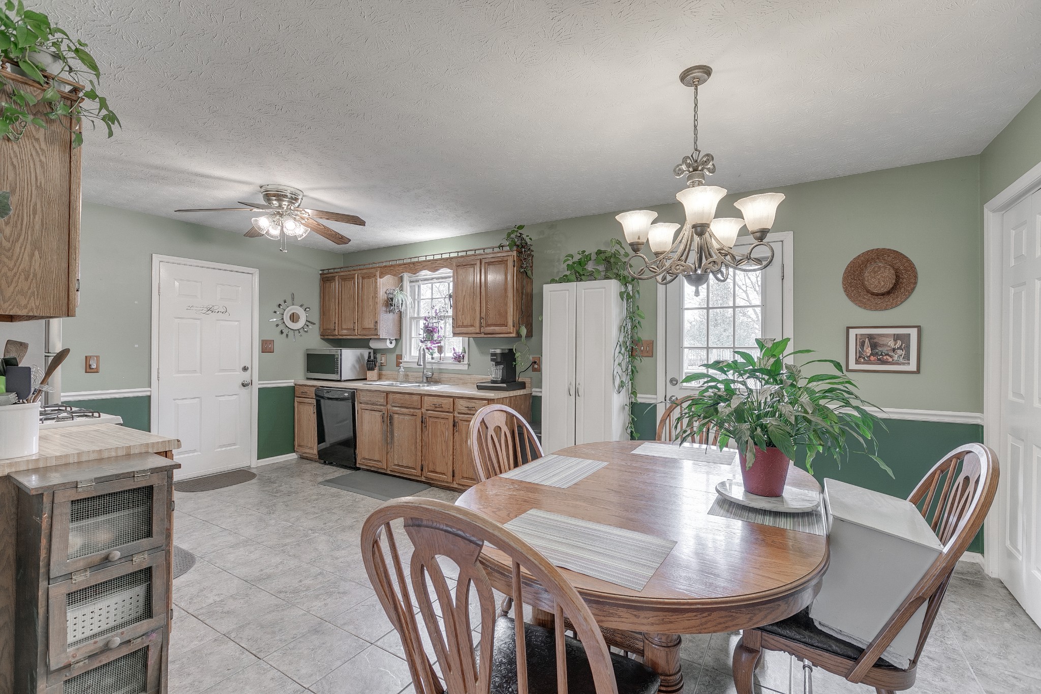 3385 Ridgefield Drive Murfreesboro, TN 37129 - Photo 8 of 25 a dining room with kitchen island stainless steel appliances furniture a chandelier and kitchen view