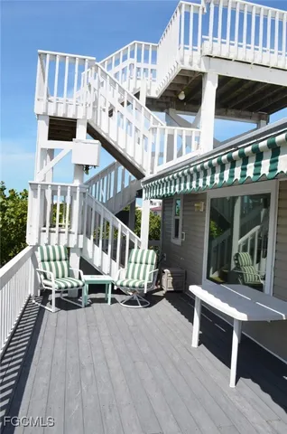 a roof deck with a table and chairs