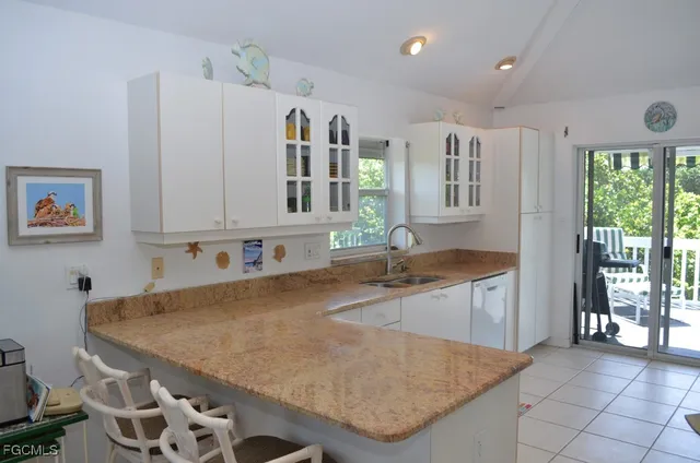 a kitchen with stainless steel appliances granite countertop a sink a stove and a refrigerator