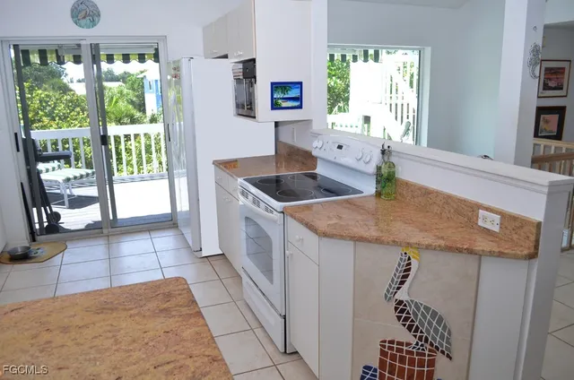 a kitchen with granite countertop a sink a counter top space and cabinets