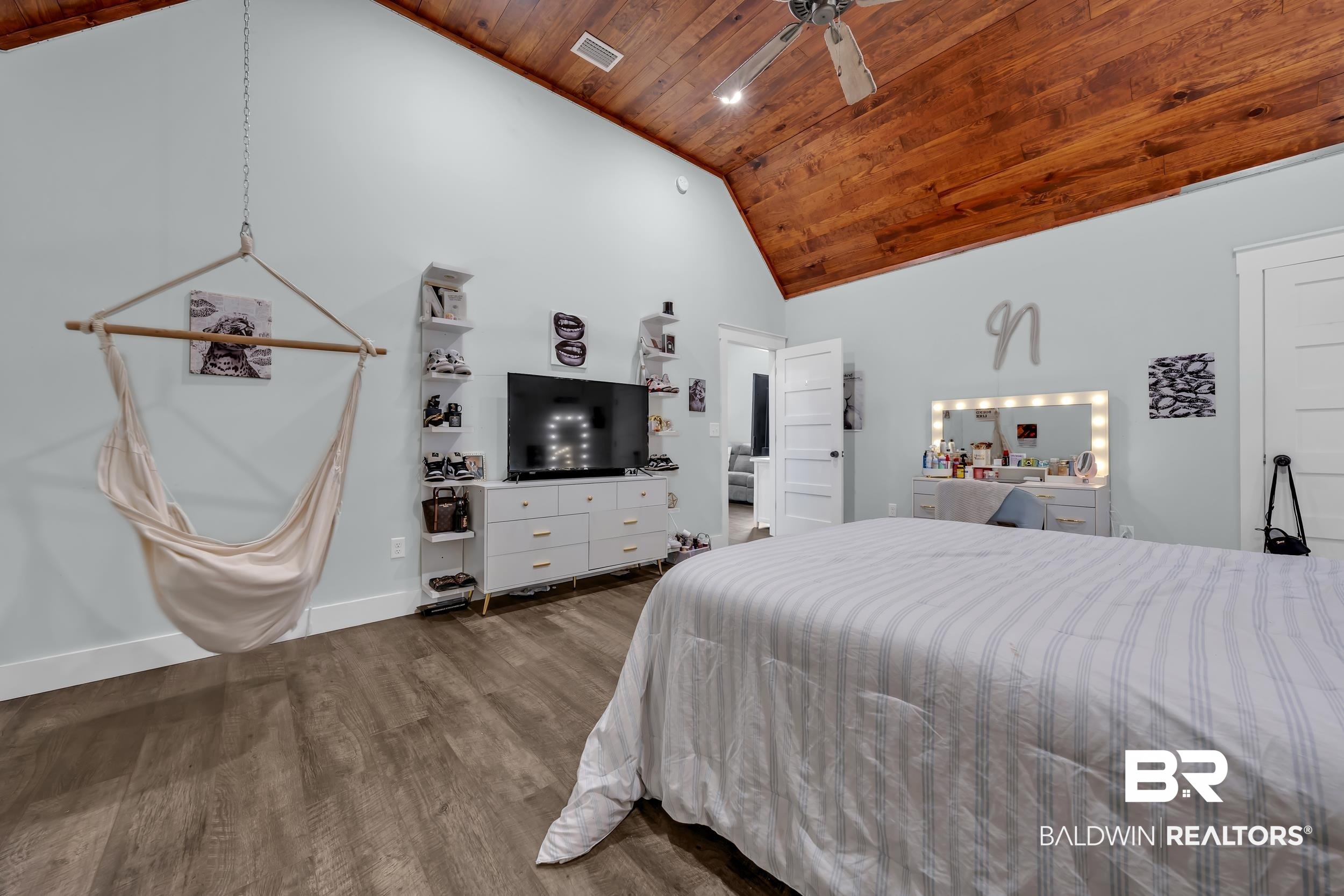 6576 Ranch Loop Road East Grand Bay, AL 36541 - Photo 28 of 39 Spacious room featuring vaulted wood-paneled ceilings with exposed beams, wood-finish flooring, and light blue wall tones