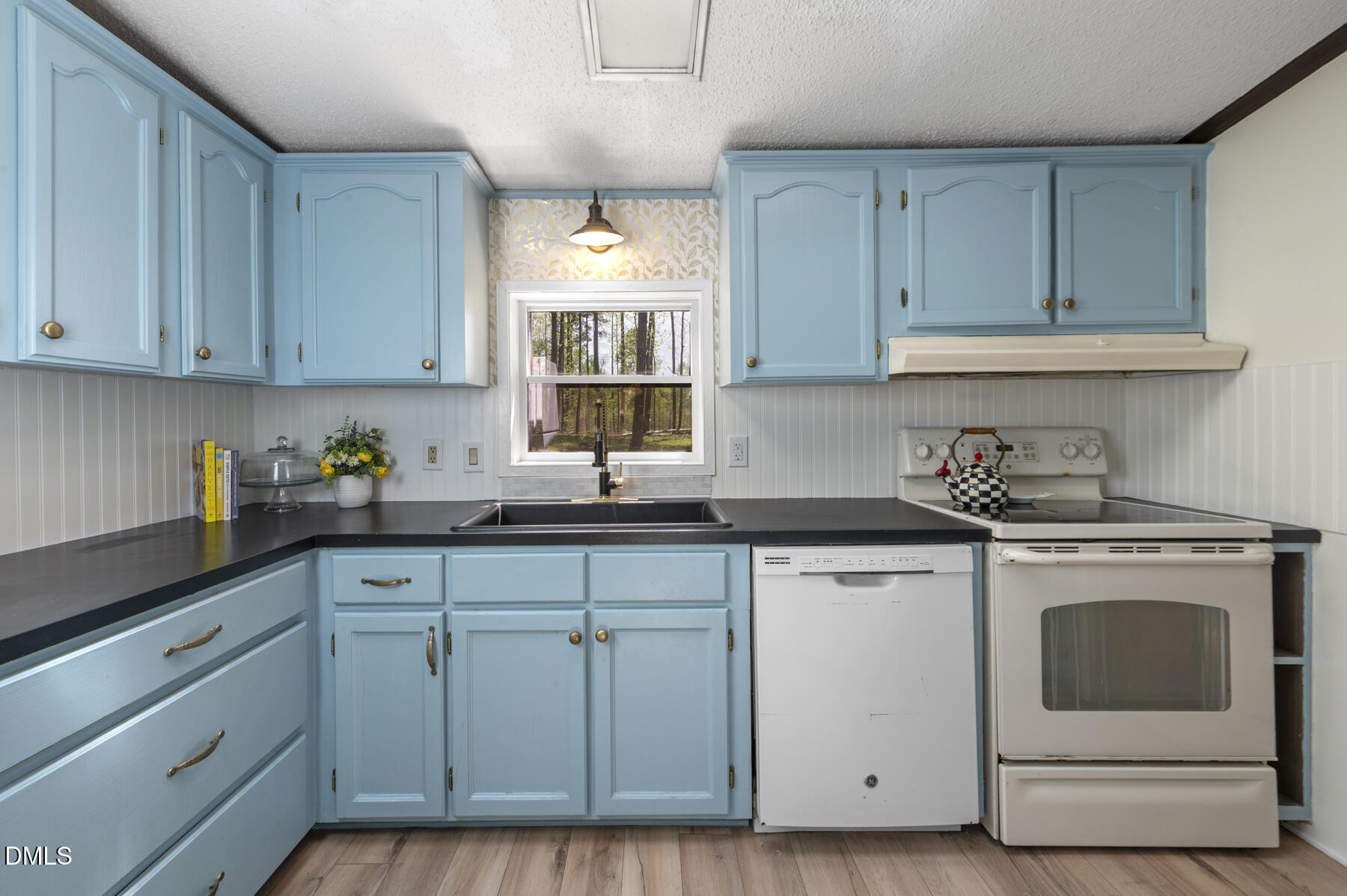 492 Little Mill Road Henderson, NC 27537 - Photo 13 of 39 a kitchen with granite countertop white cabinets and white appliances