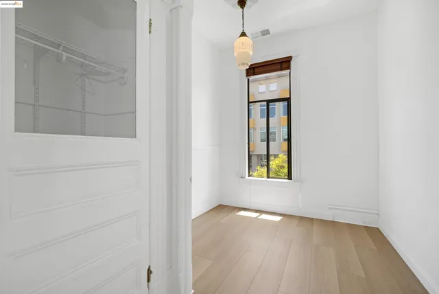 a view of a hallway with wooden floor