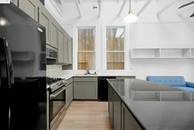 a kitchen with stainless steel appliances granite countertop sink stove top oven and cabinets