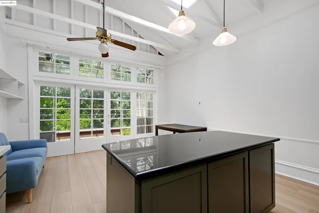 a living room with furniture a flat screen tv and a window