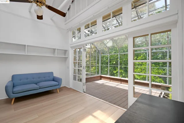 a living room with furniture and a floor to ceiling window