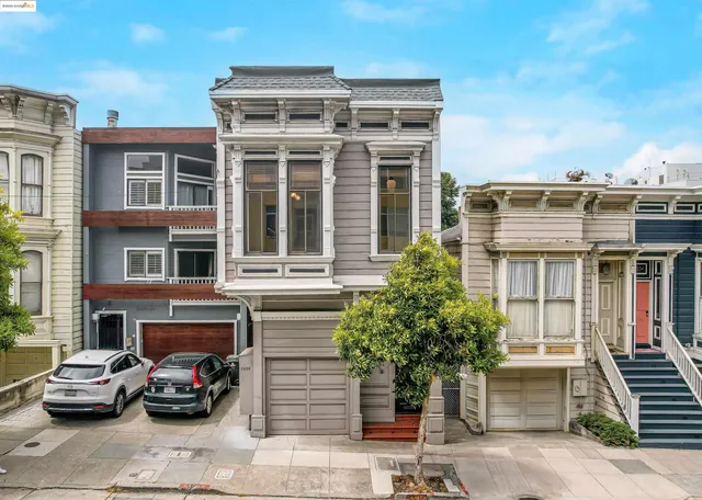 a view of a hallway with windows and flower pot