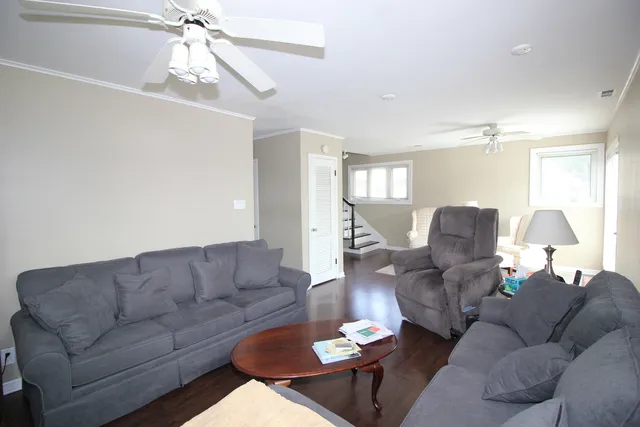 a living room with furniture and a chandelier