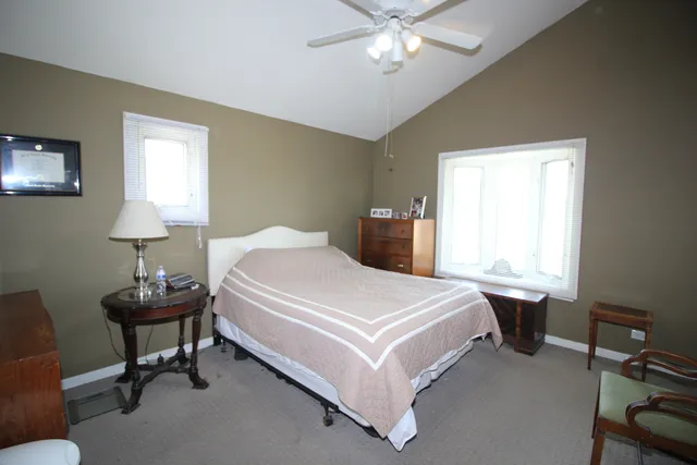 a bedroom with a bed and a table lamp