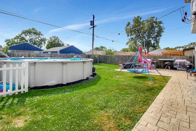 a view of a house with a yard and sitting area