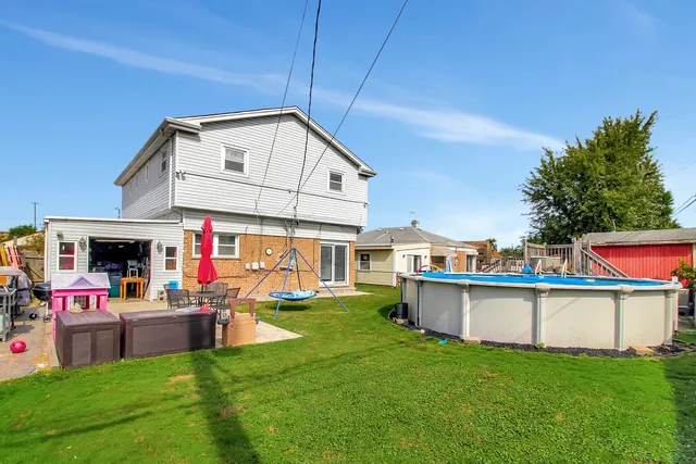 a view of a house with a backyard and a patio