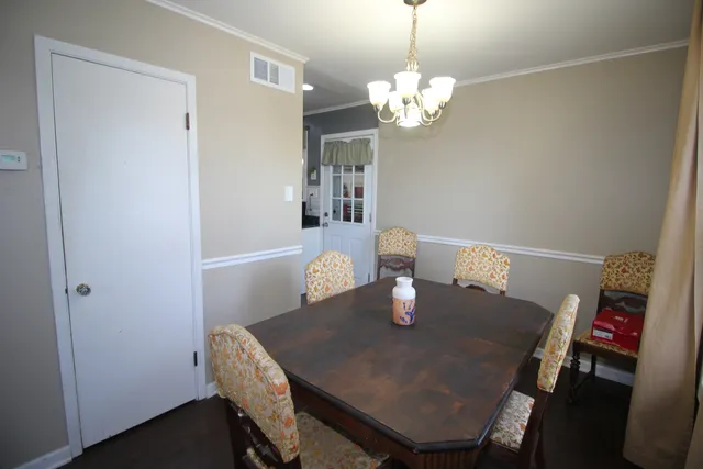 a view of a dining room with a table and chairs