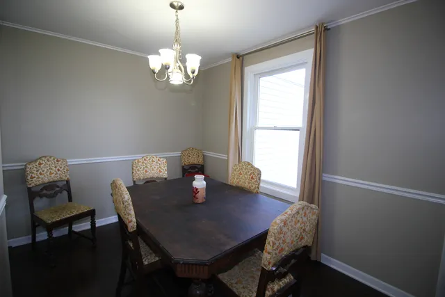 a view of a dining room with a table and chairs