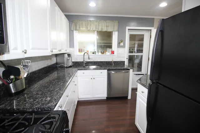 a kitchen with a sink stove and refrigerator