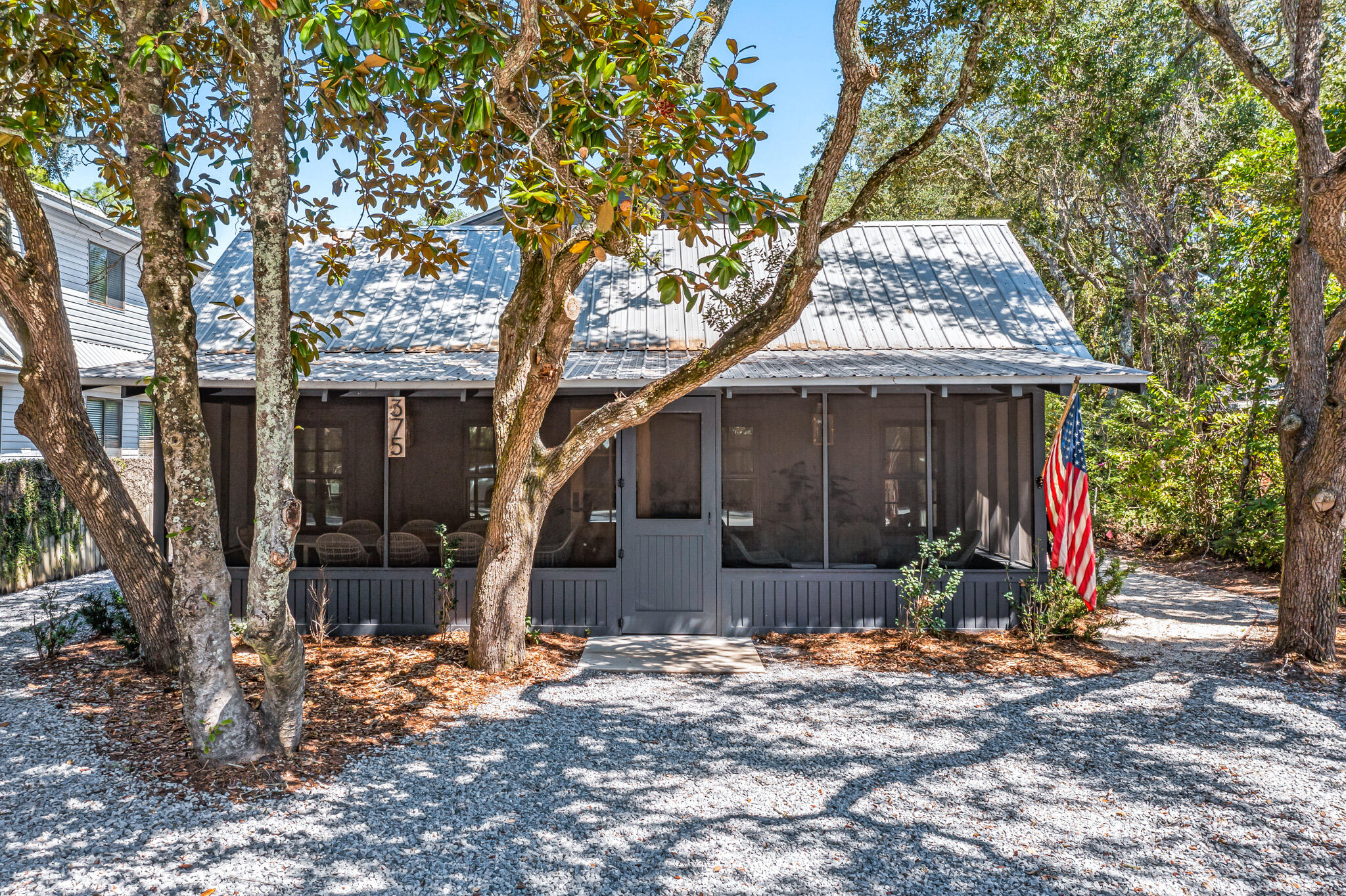 375 Defuniak Street Santa Rosa Beach, FL 32459 - Photo 3 of 94 a front view of a house with garden