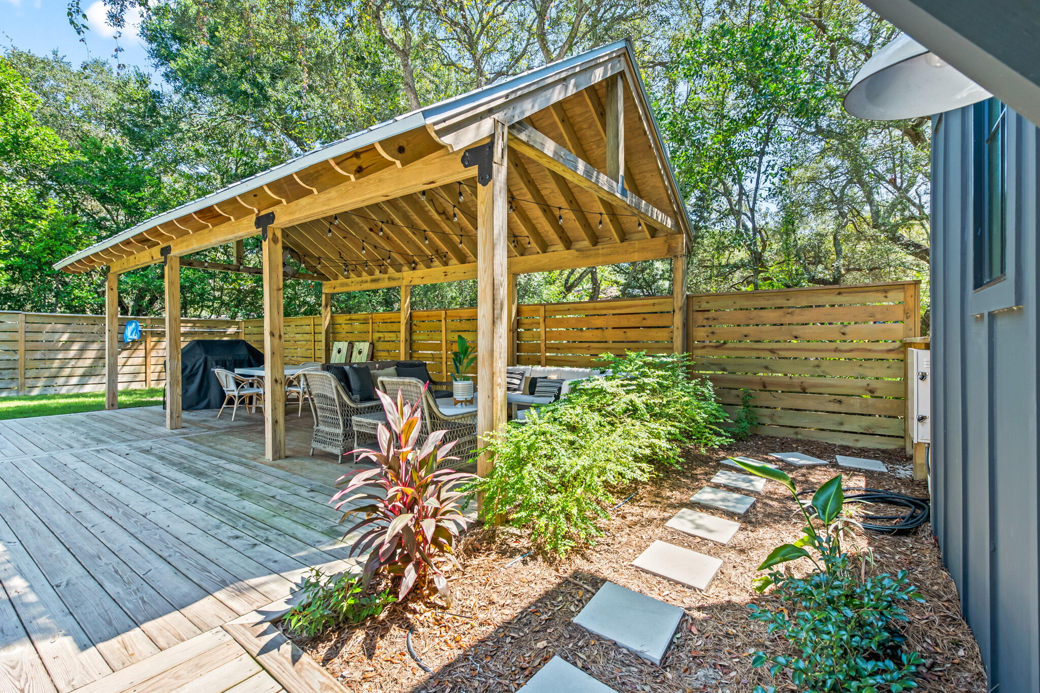 375 Defuniak Street Santa Rosa Beach, FL 32459 - Photo 75 of 94 a view of a patio with table and chairs potted plants with wooden floor and fence