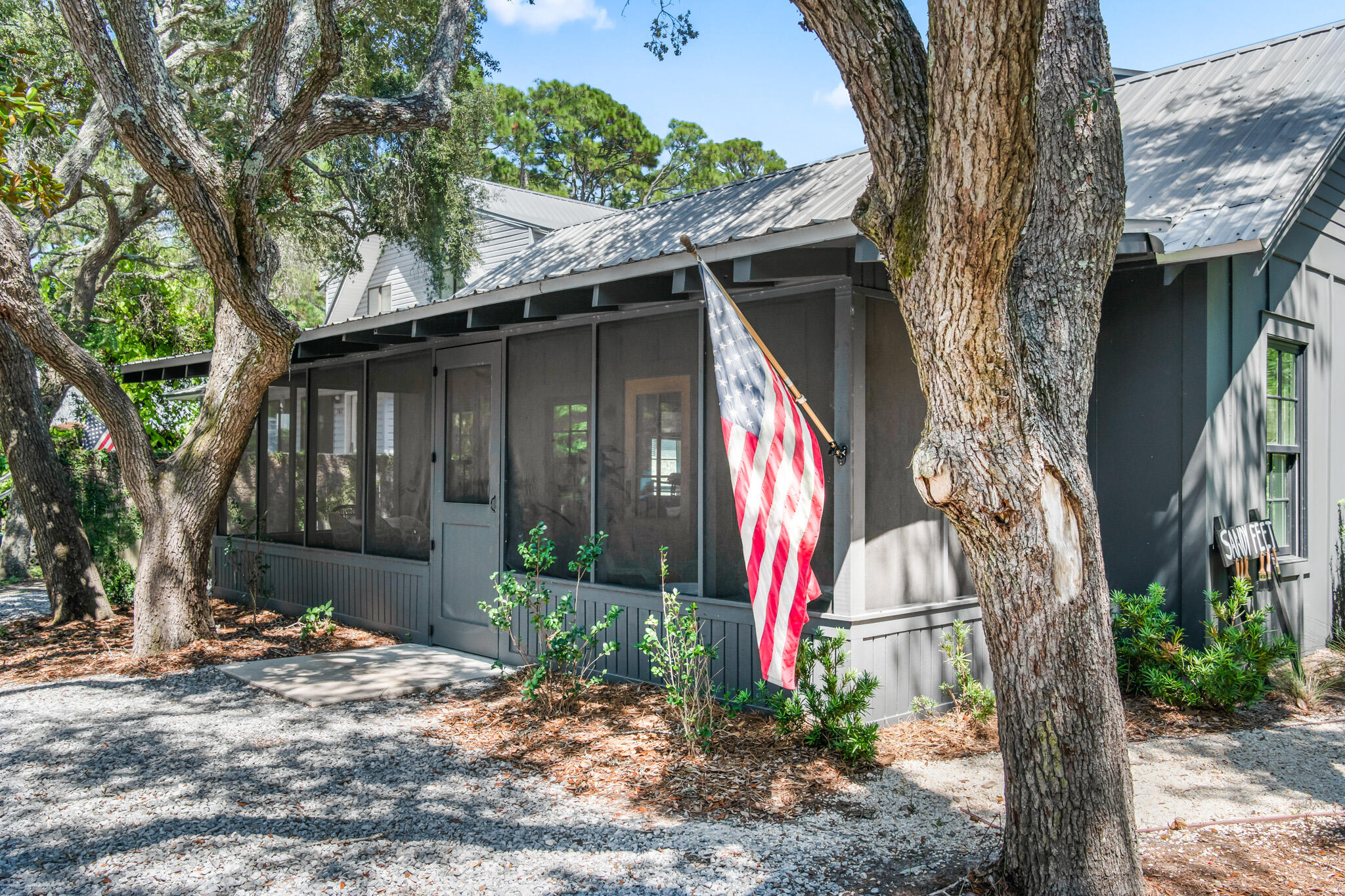 375 Defuniak Street Santa Rosa Beach, FL 32459 - Photo 83 of 94 a view of a wooden house with a small yard and large tree