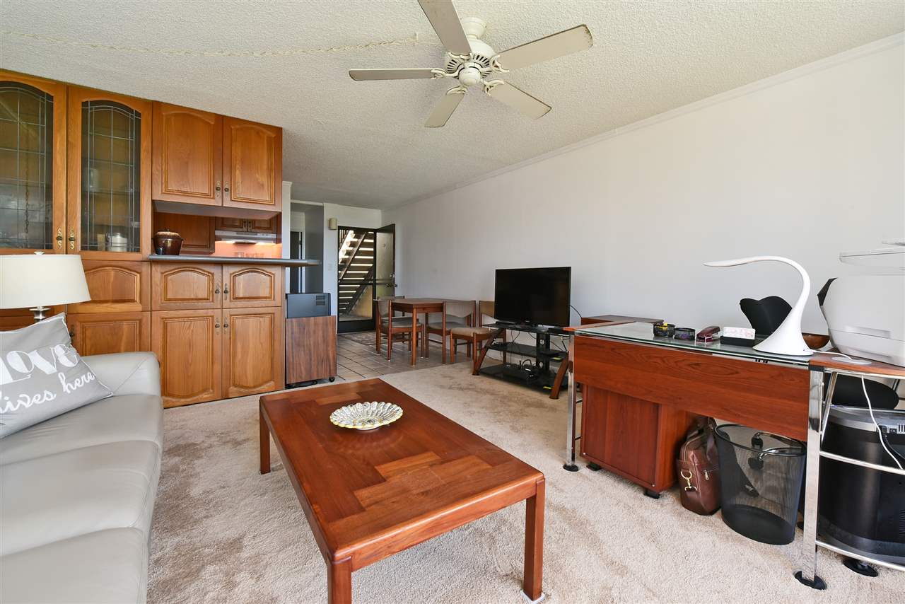 120 Hui Rd F, Unit B5 Lahaina, HI 96761 - Photo 27 of 28 a living room with furniture a flat screen tv and kitchen view