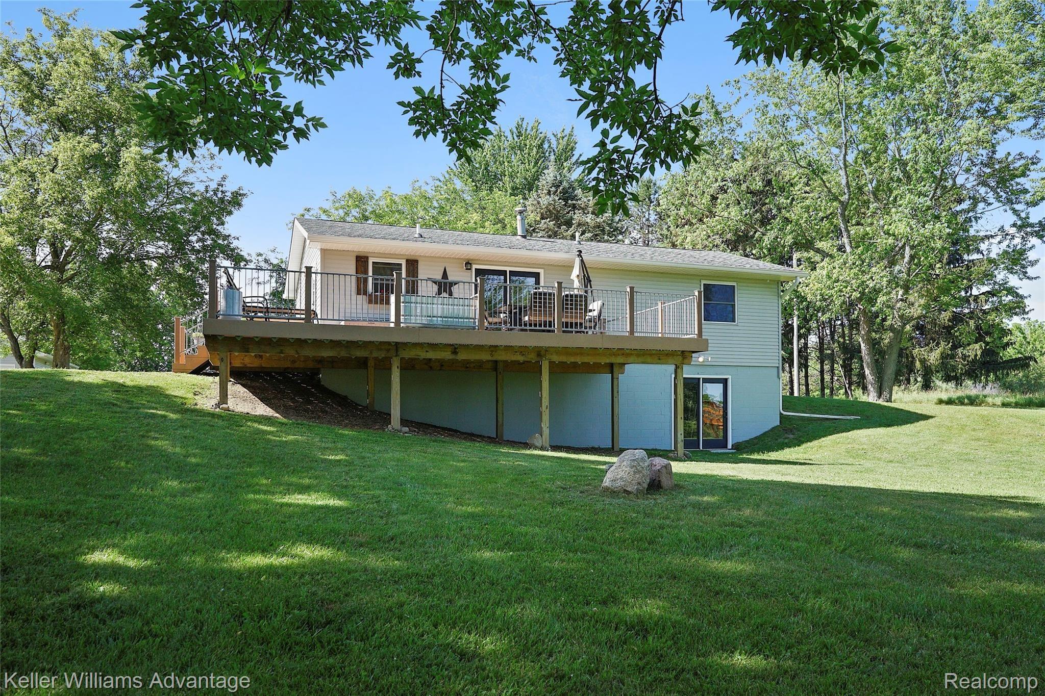 944 Chase Lake Road Howell, MI 48855 - Photo 29 of 36 Walkout lower level, and extensive deck (low-maintenance composite decking). Deck is accessible from slider door and kitchen entrance.
