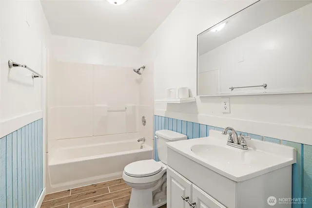 a bath room with a sink a toilet and a bathtub