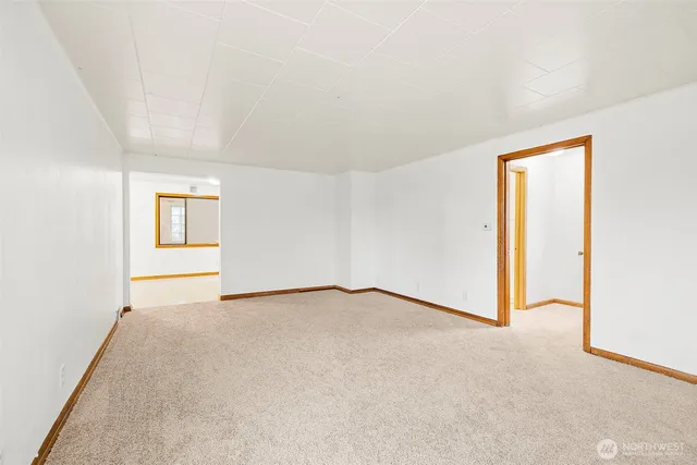 an empty room with windows and closet