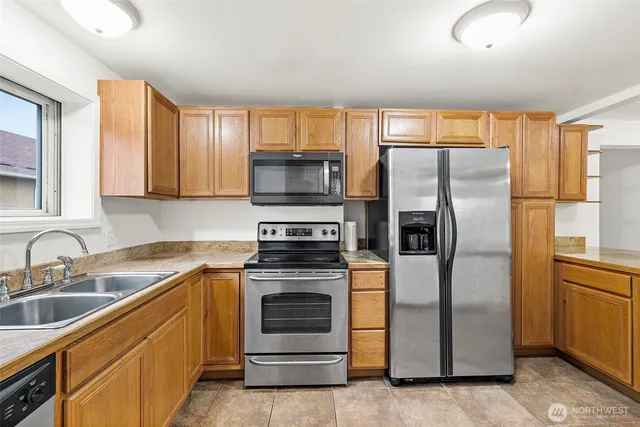 a kitchen with a refrigerator sink and microwave