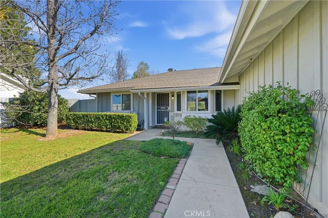 a front view of a house with yard and green space