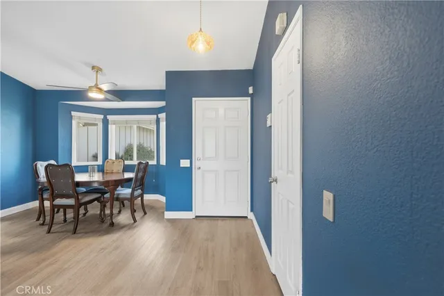 a dining room with furniture and wooden floor