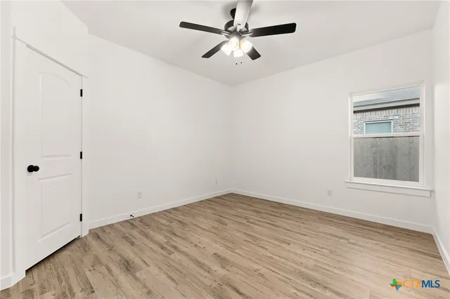 wooden floor in an empty room with a window