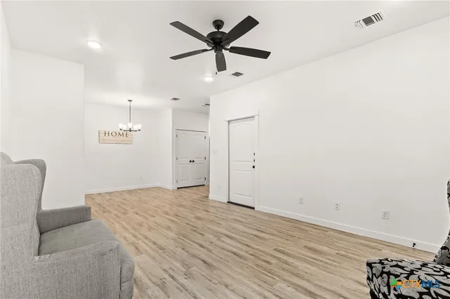 a view of livingroom with hardwood floor and a ceiling fan