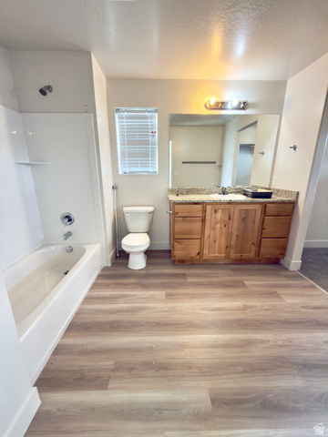 1823 South Longview Road Santaquin, UT 84655 - Photo 50 of 69 Full bathroom featuring a tub/shower combination, wood-finish flooring, a vanity with granite-style countertop, and a built-in mirror with overhead lighting