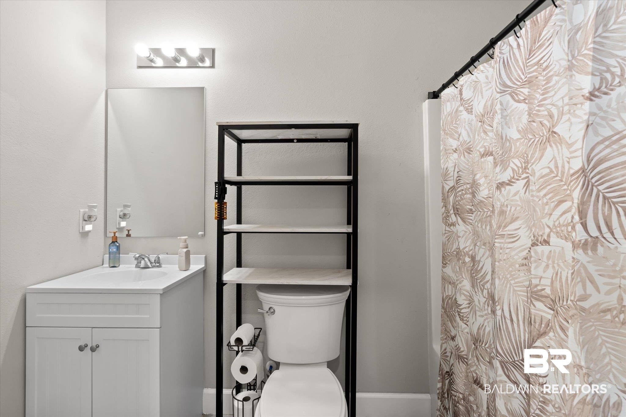 708 Fisher Street Mobile, AL 36607 - Photo 12 of 17 Bathroom with vanity, toilet, and a shower with shower curtain