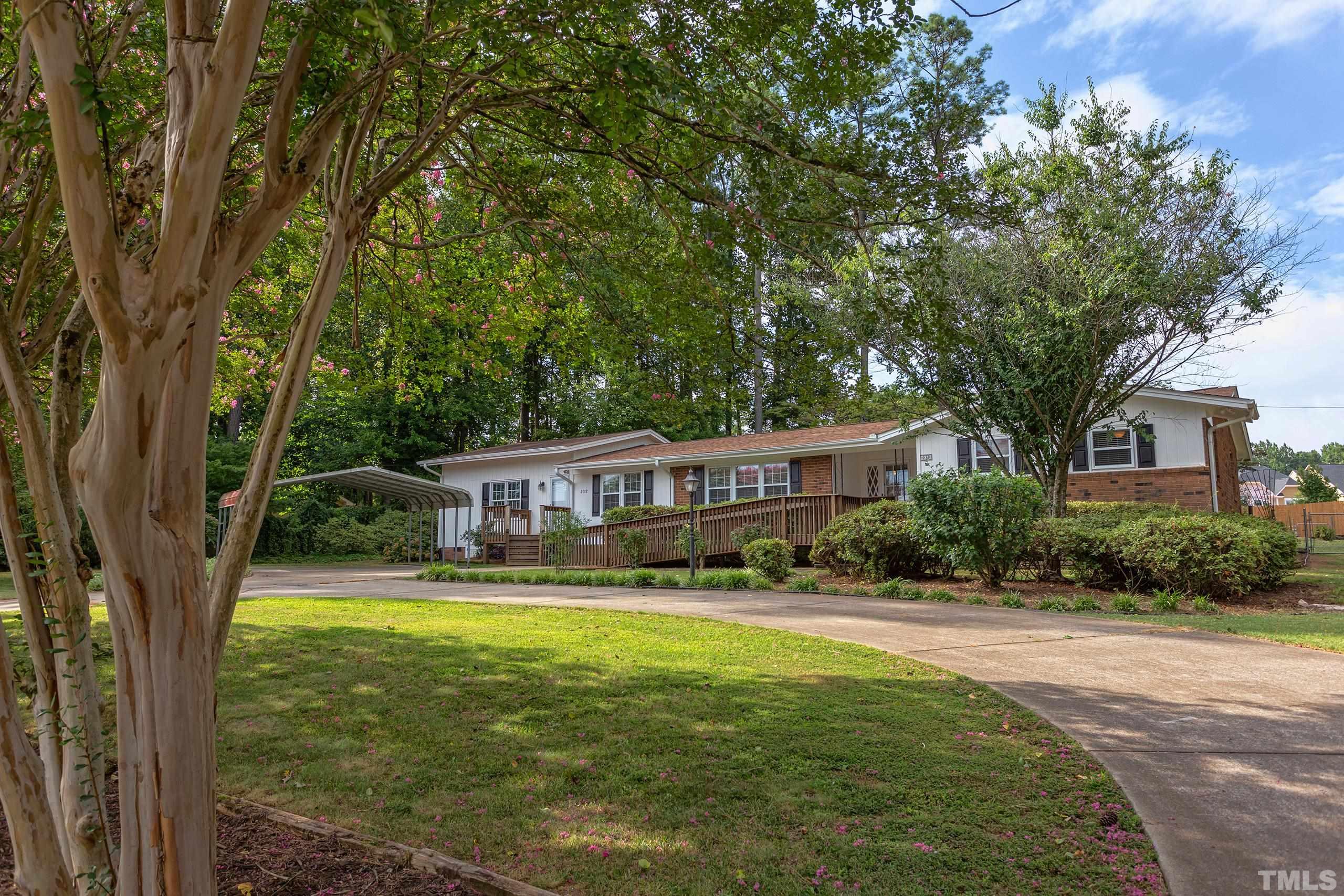 2312 Gresham Lake Road Raleigh, NC 27615 - Photo 1 of 46 a front view of a house with a yard