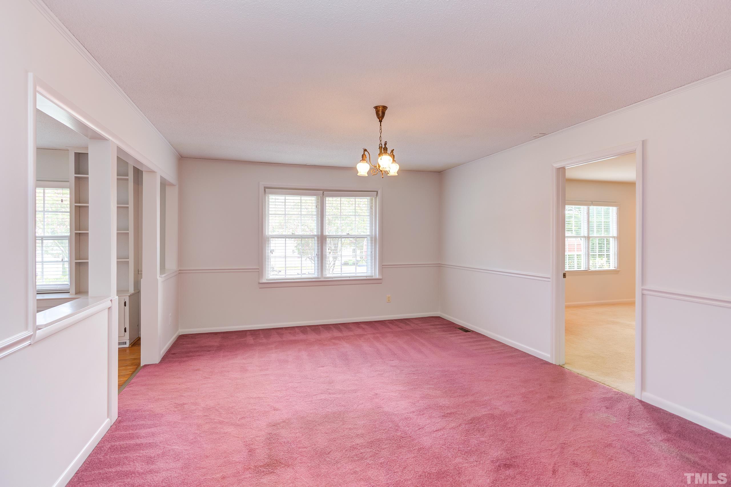 2312 Gresham Lake Road Raleigh, NC 27615 - Photo 12 of 46 an empty room with windows and chandelier fan