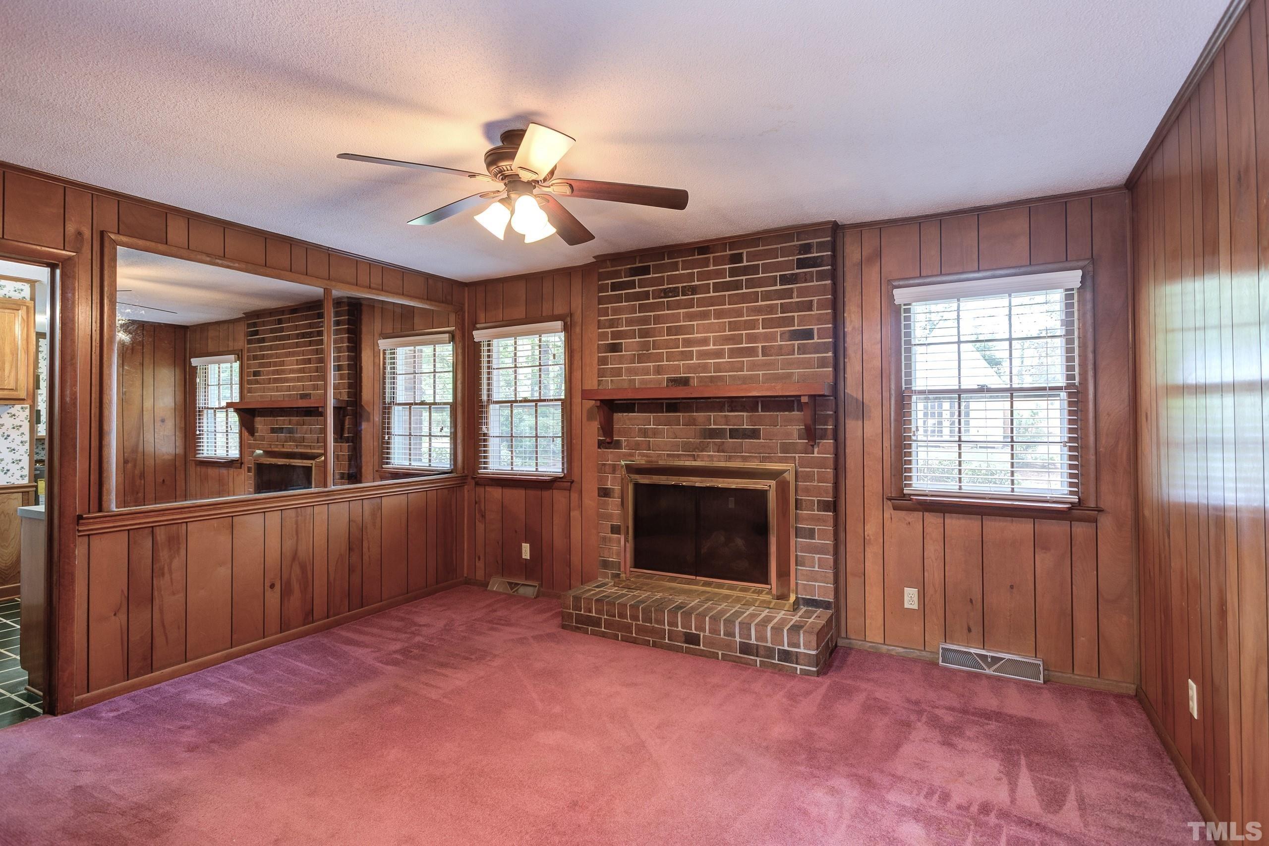 2312 Gresham Lake Road Raleigh, NC 27615 - Photo 16 of 46 wooden floor fireplace and windows in an empty room