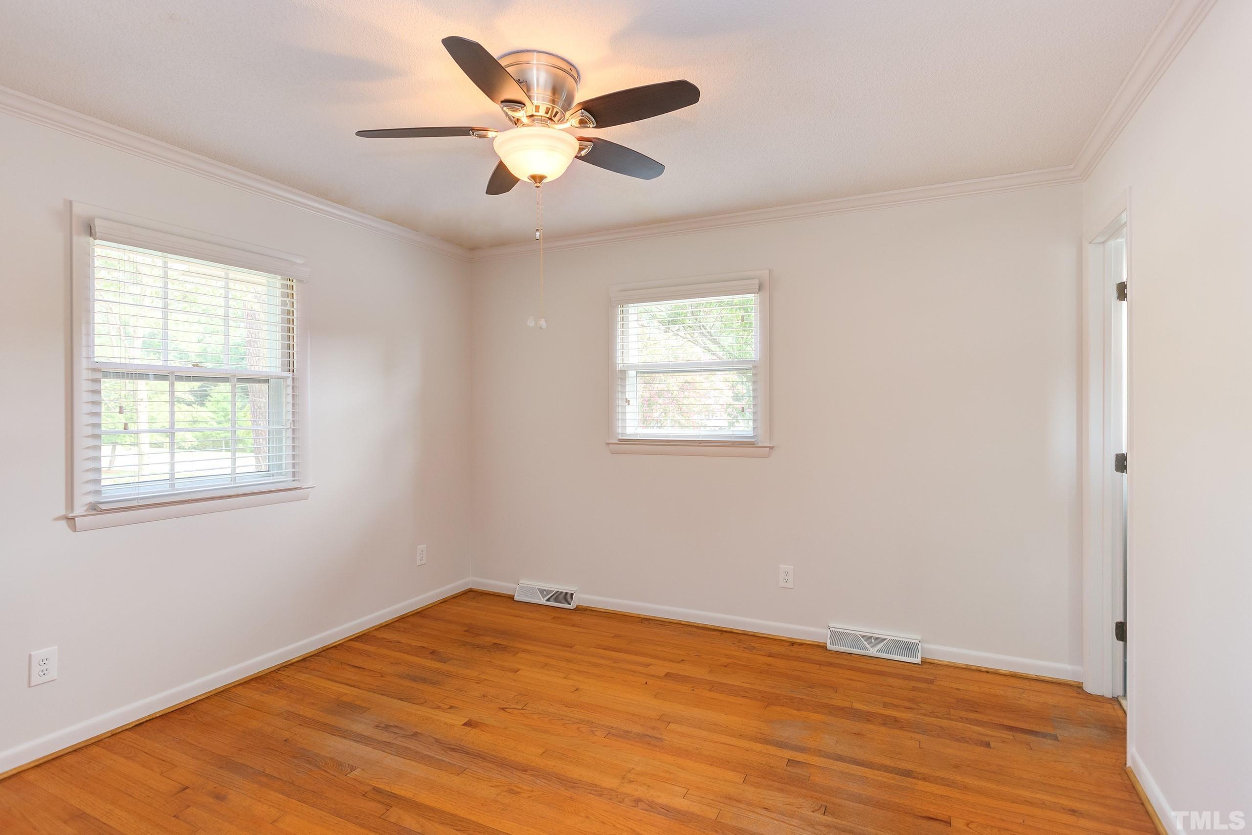 2312 Gresham Lake Road Raleigh, NC 27615 - Photo 20 of 46 a view of an empty room with wooden floor and a window