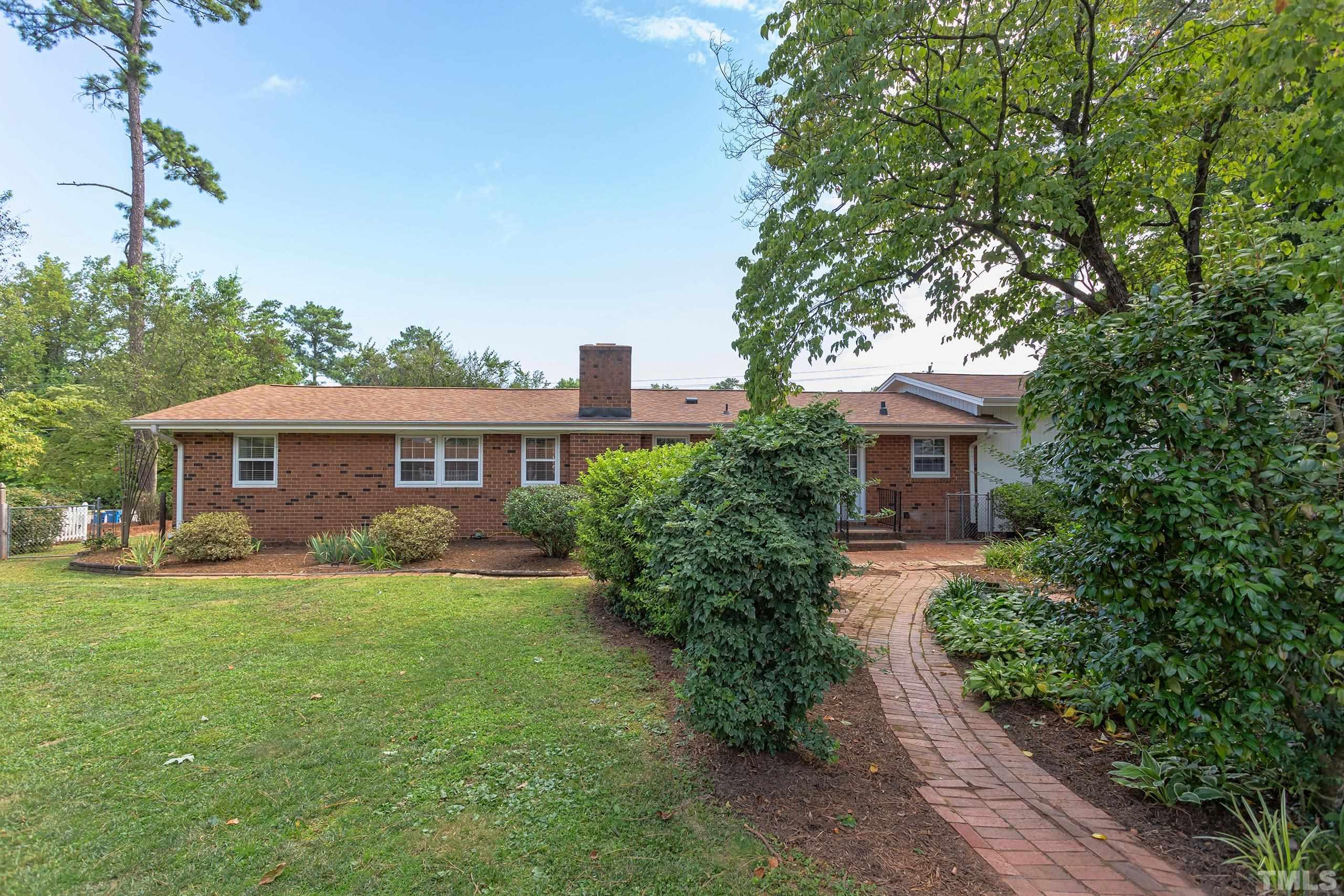 2312 Gresham Lake Road Raleigh, NC 27615 - Photo 2 of 46 a front view of a house with a garden