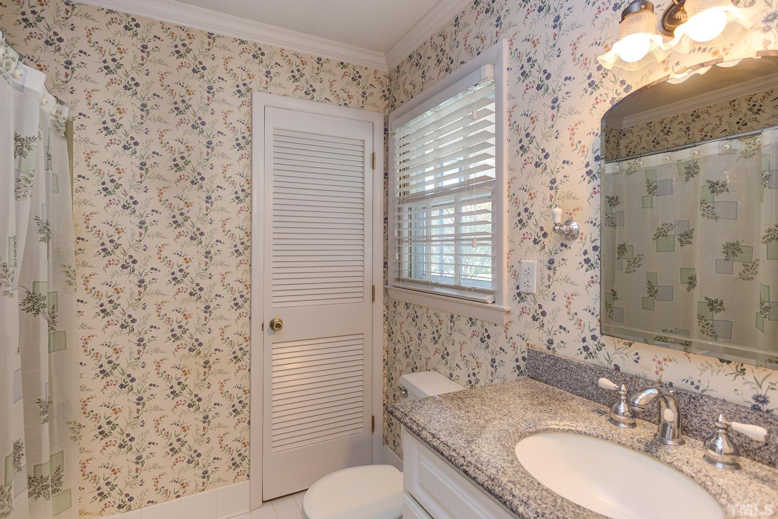 2312 Gresham Lake Road Raleigh, NC 27615 - Photo 23 of 46 a bathroom with a granite countertop sink toilet and shower