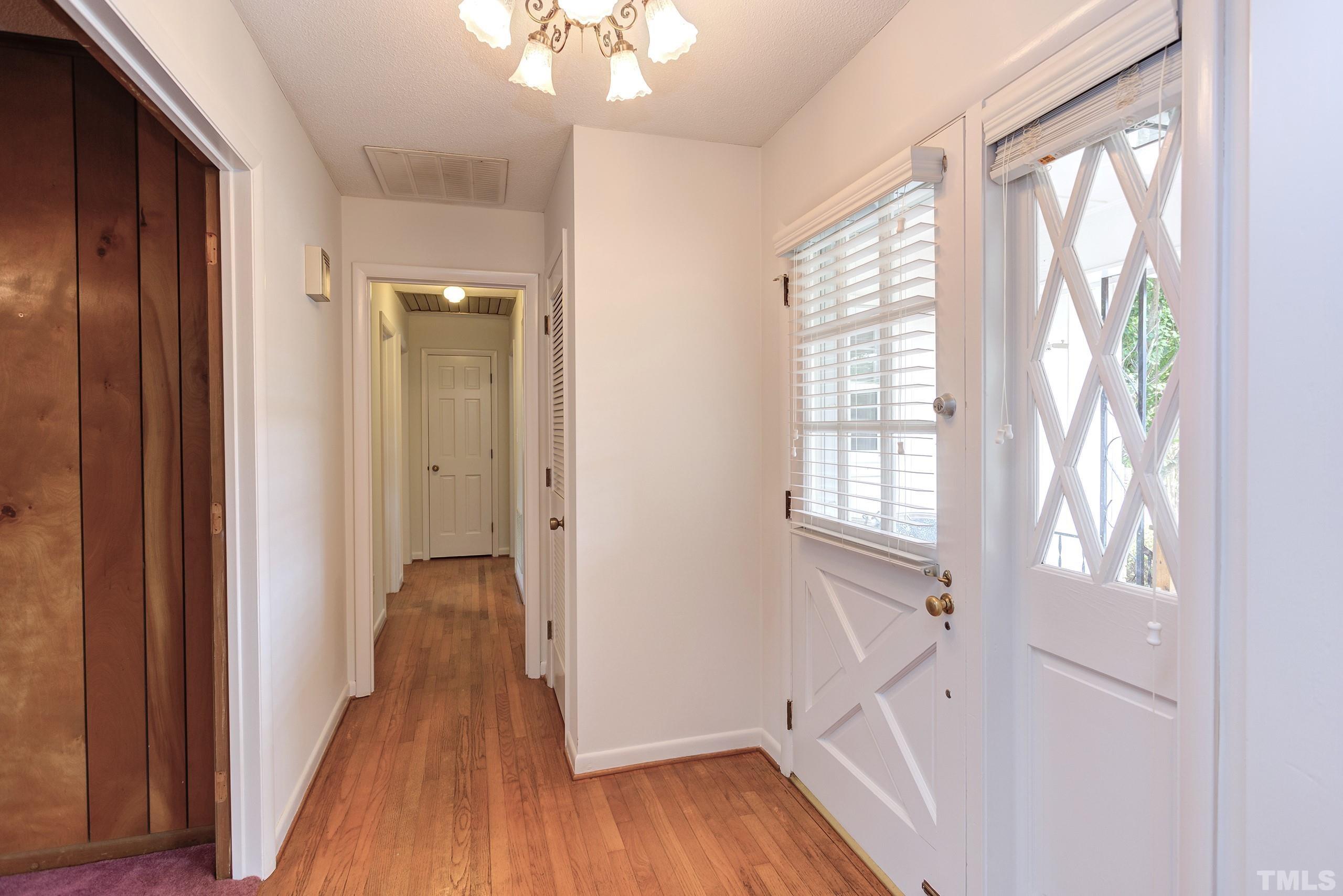 2312 Gresham Lake Road Raleigh, NC 27615 - Photo 25 of 46 a view of a hallway with wooden floor and windows