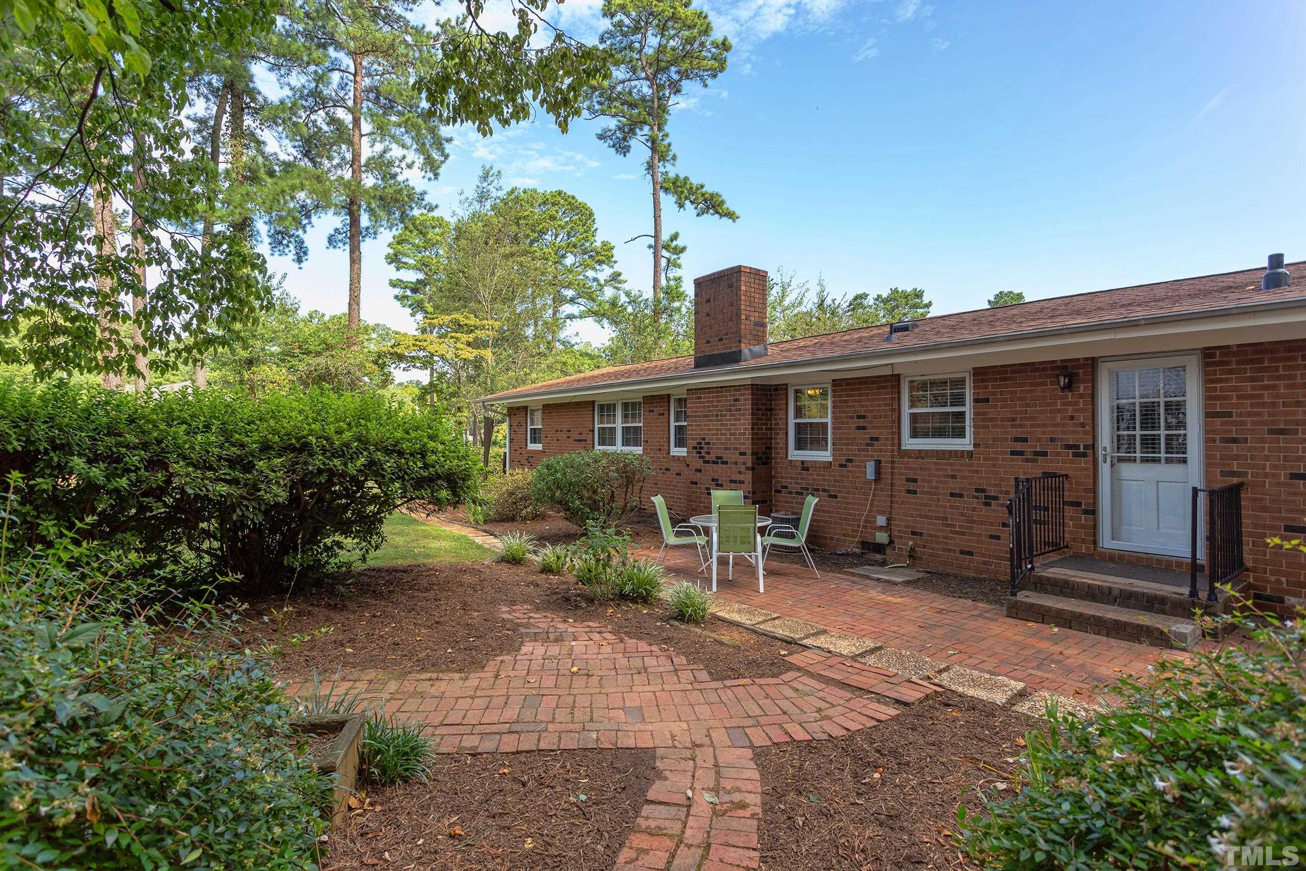 2312 Gresham Lake Road Raleigh, NC 27615 - Photo 27 of 46 a front view of a house with garden and furniture