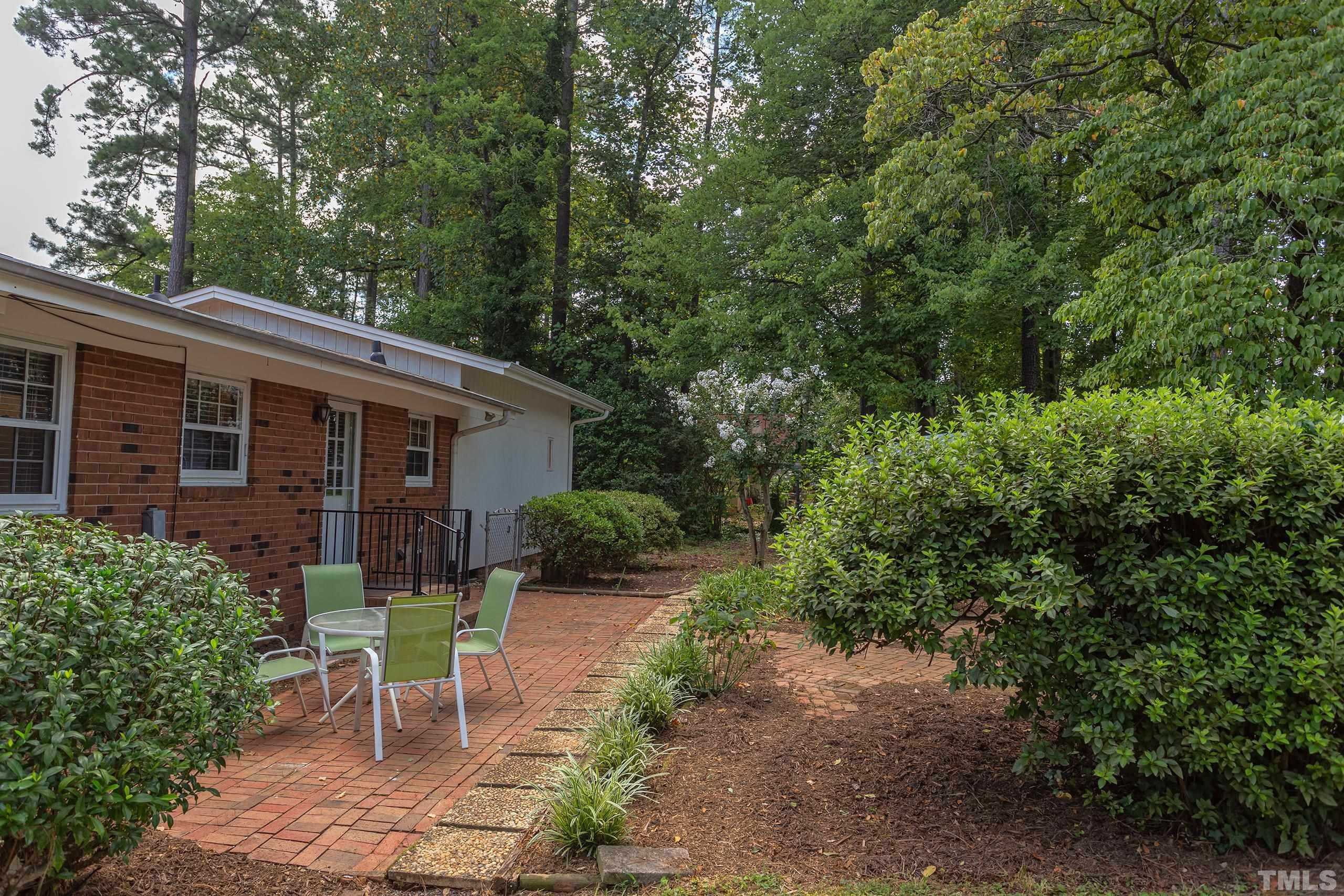 2312 Gresham Lake Road Raleigh, NC 27615 - Photo 28 of 46 a view of a chair and table in backyard of the house