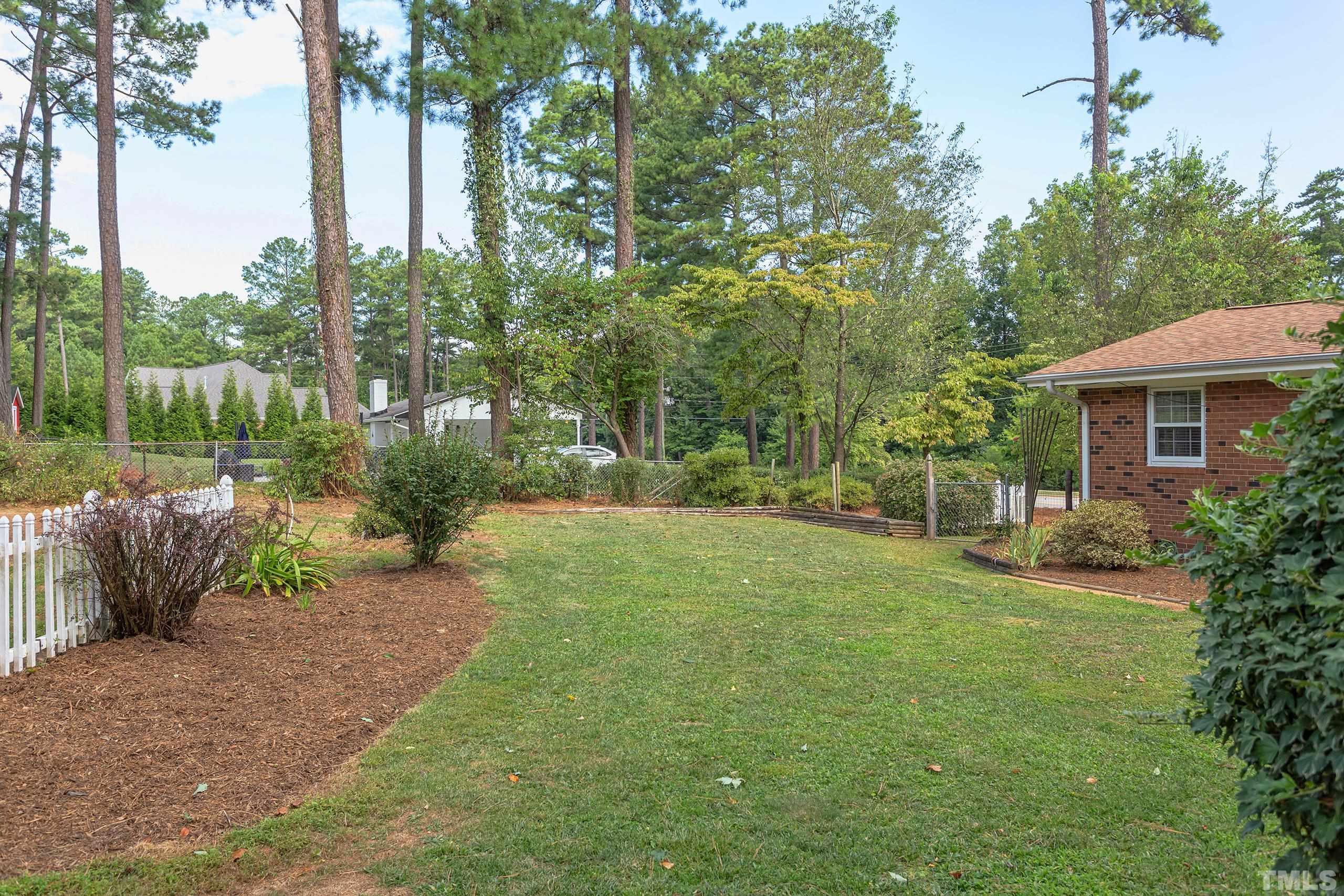 2312 Gresham Lake Road Raleigh, NC 27615 - Photo 29 of 46 a view of a backyard with garden and plants