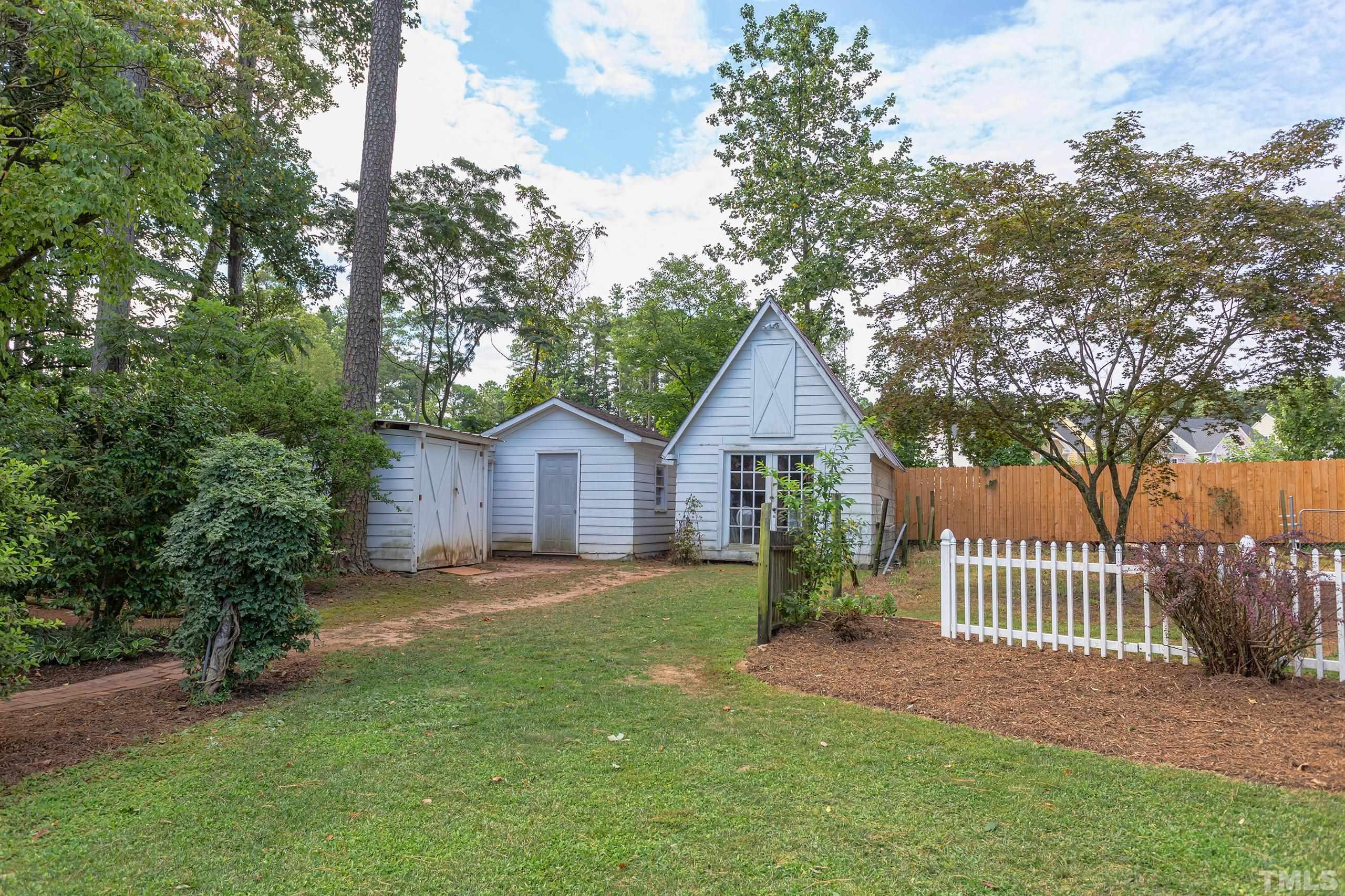 2312 Gresham Lake Road Raleigh, NC 27615 - Photo 30 of 46 a view of a yard in front of a house with large trees